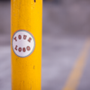 round-sticker-on-a-yellow-pole-in-a-parking-lot-mockup-a14345 (1)